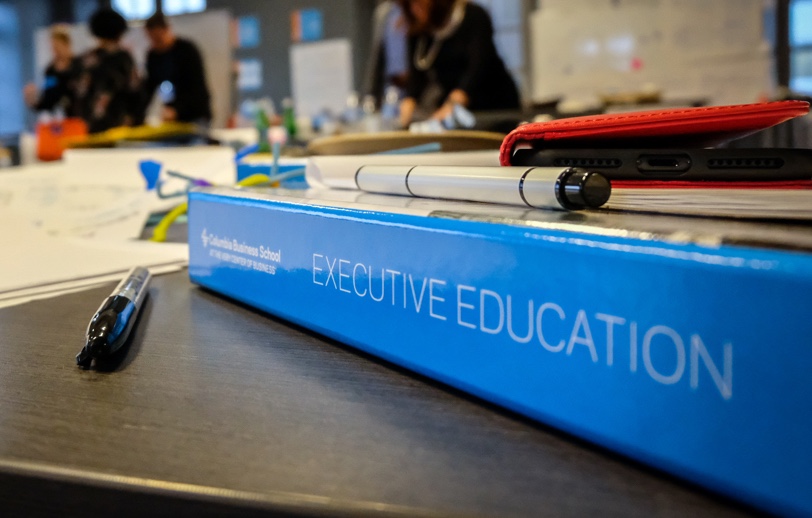 binder with Executive Education written down the spine